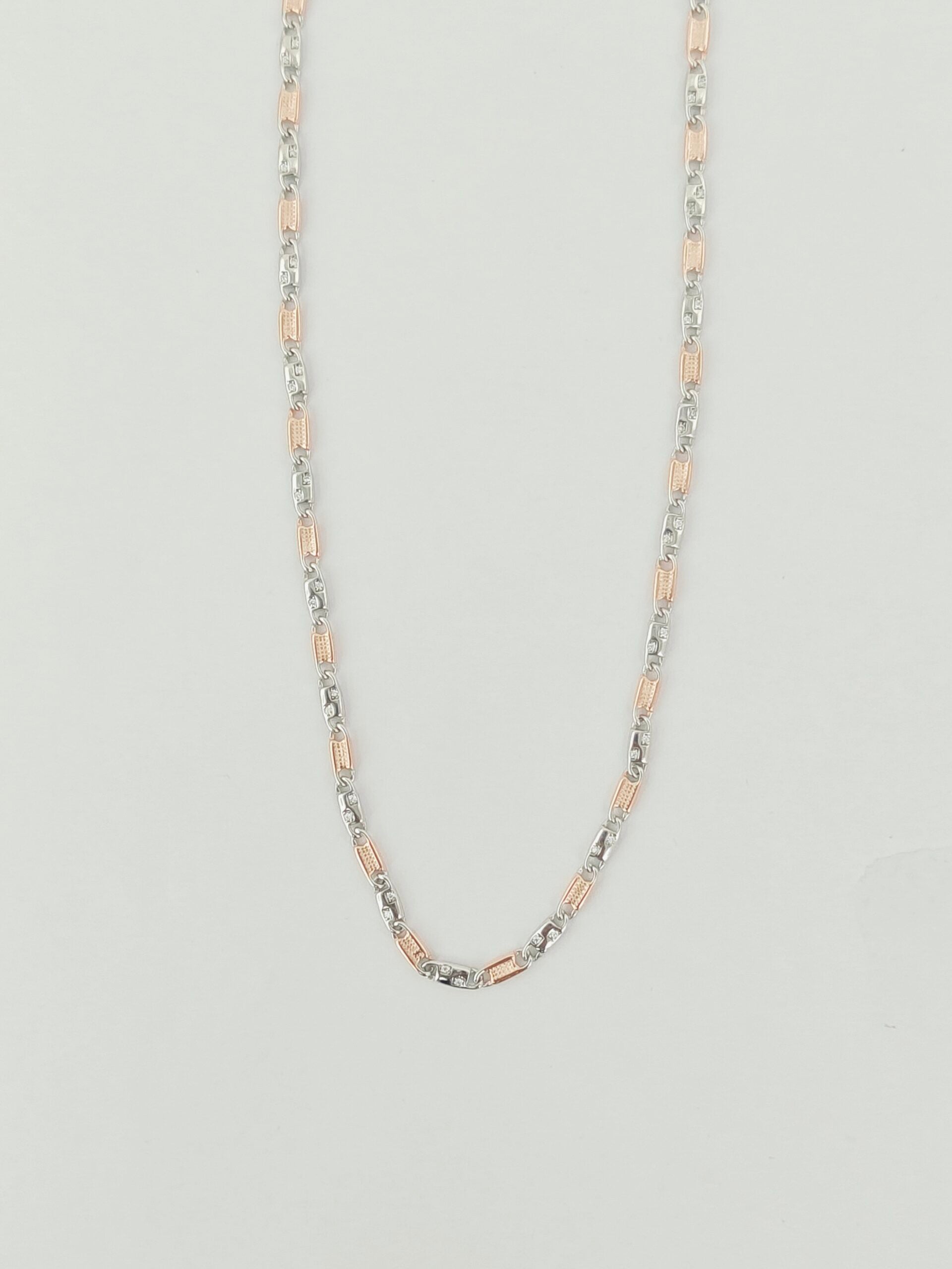 Two-tone chain necklace on a light gray background